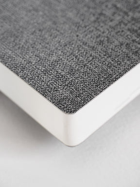 Durable daily planner featuring a textured, speckled dark gray cover contrasted by clean white binding edges.