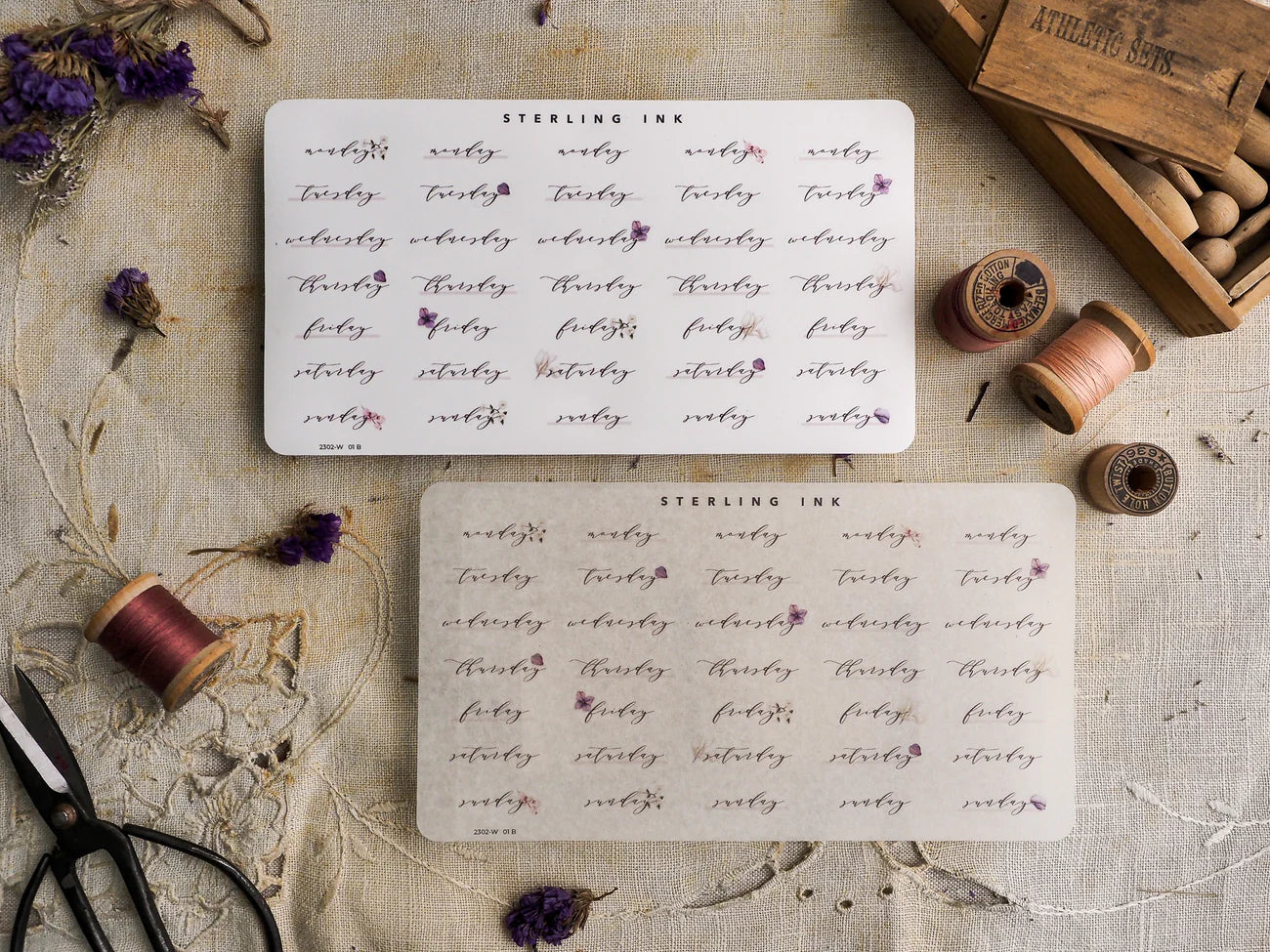 A cohesive set of white planning stickers featuring "STEARLING INK" centered above a grid pattern of handwritten date markers, ideal for journal decorating.