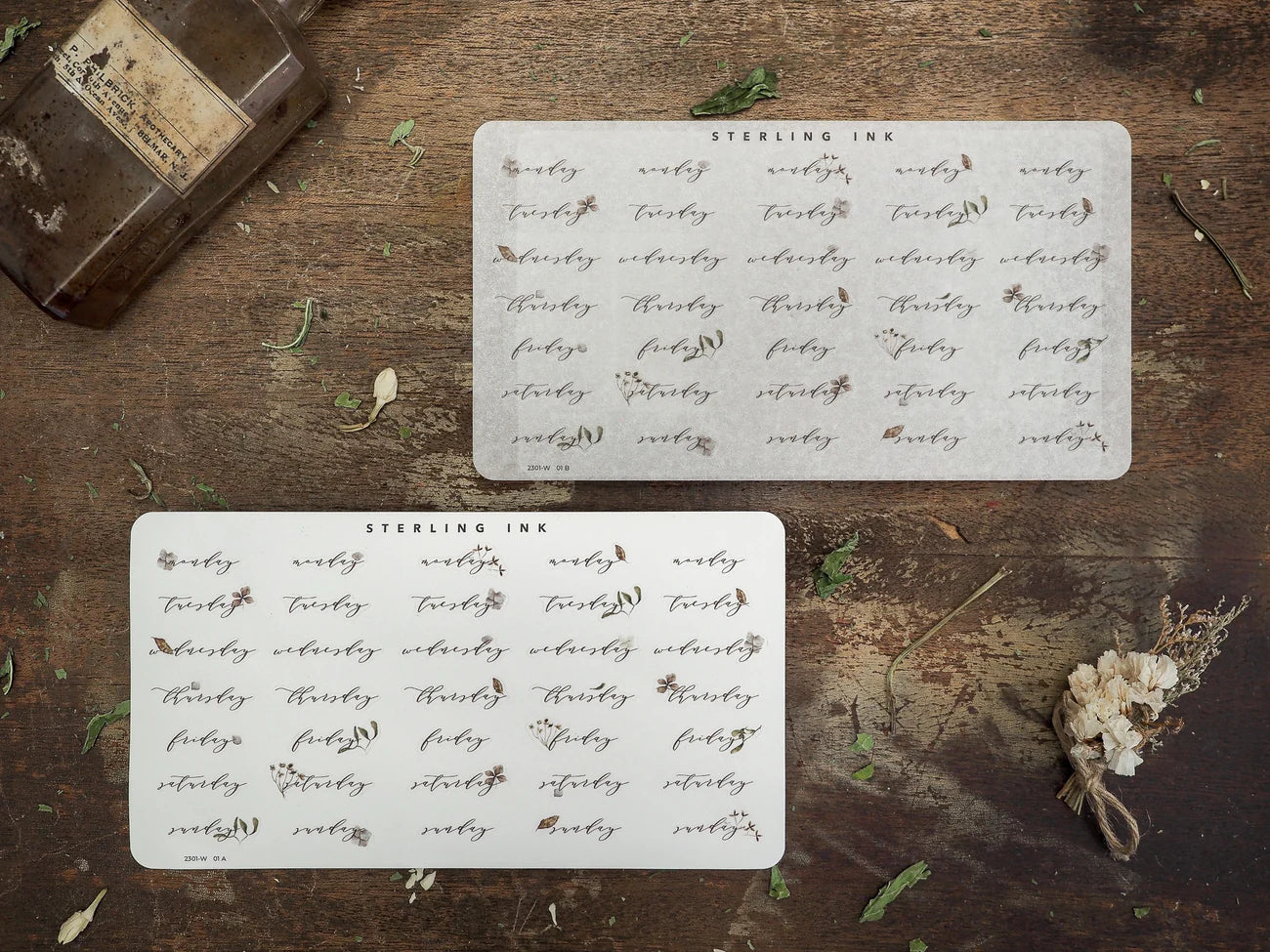 A sticker set for planners featuring white, patterned stickers with calendar dates and months, perfect for organizing and decorating a weekly journal or bullet journal.