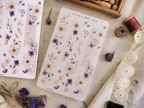 Delicate washi sticker sheet featuring a watercolor pattern of tiny purple, dusty blue, and pink wildflowers under the text "STERLING INK."