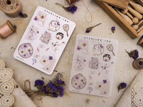 February 2023 sticker sheet featuring delicate pastel floral illustrations, vintage apothecary icons, and shimmering silver foil accents.