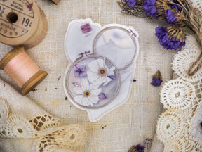 Delicate die-cut vinyl sticker sheet featuring a pale floral arrangement of white and lilac daisy-like blooms perfect for planning or journaling.