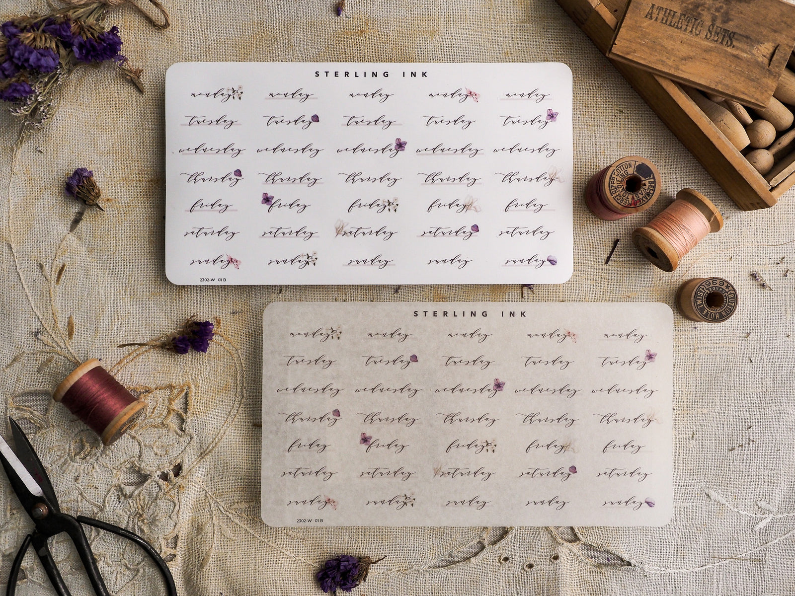 A set of white planner stickers featuring a light purple cursive design with floral accents, perfect for weekly organization and planning.