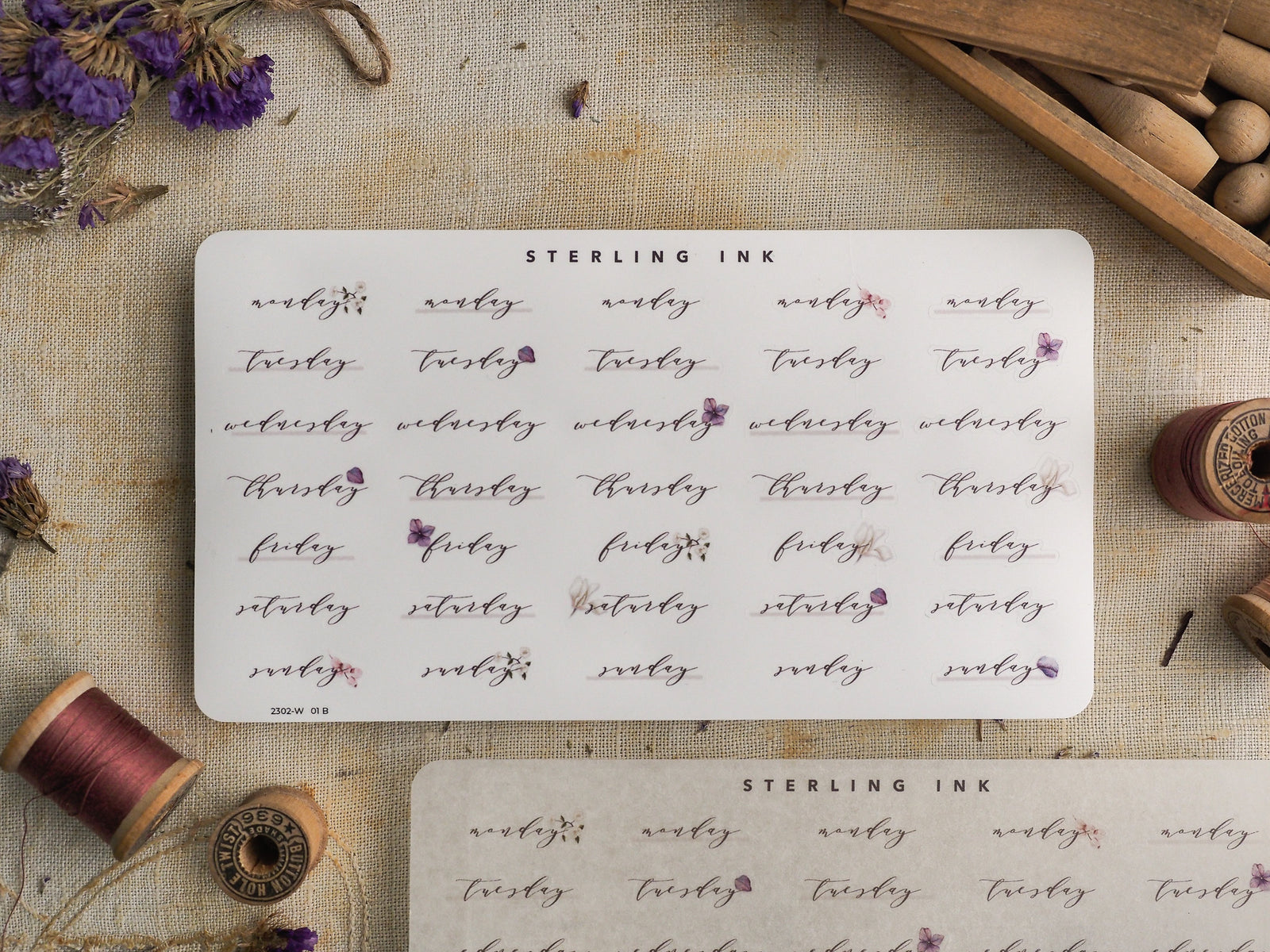 Decorative sticker sheet for February 2023, featuring handwritten weekdays, calendar dates, and elegant floral accents for journal planning.