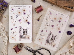 Watercolor sticker sheet featuring pale botanical arrangements of purple blooms and a delicate vintage house illustration from Sterling Ink.