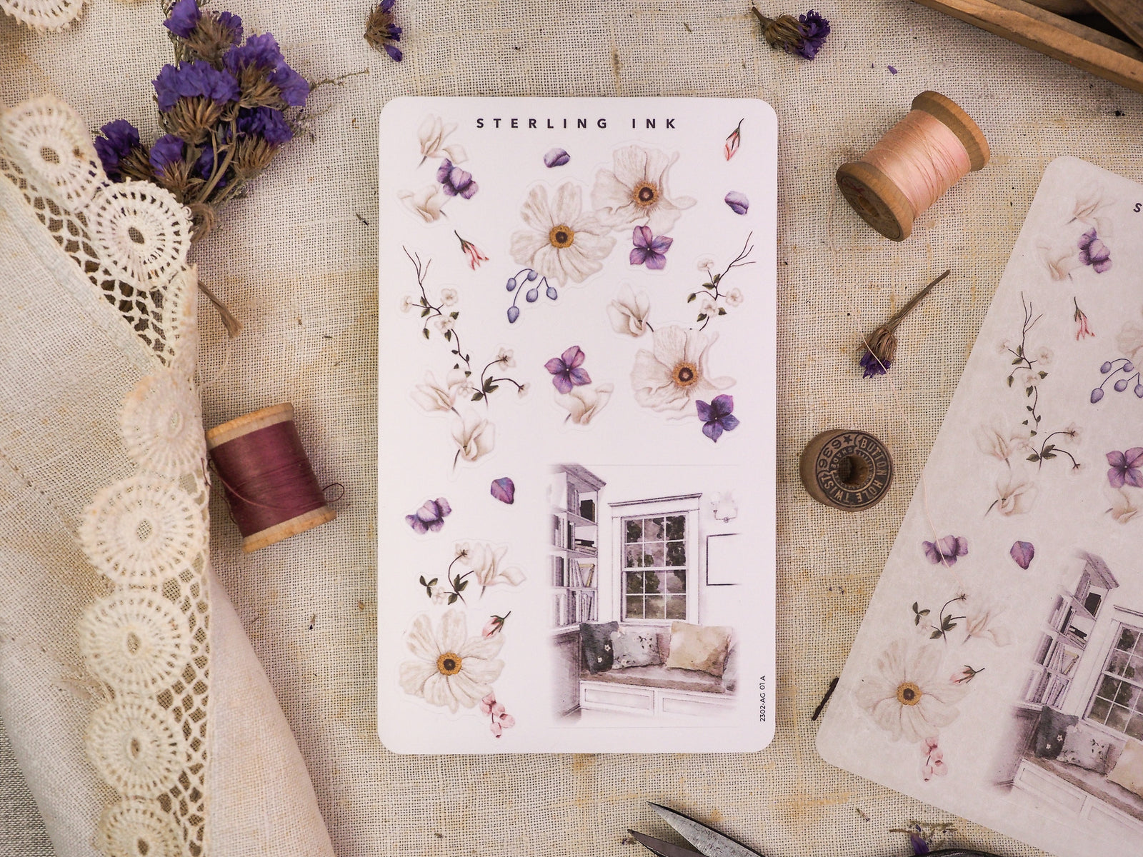 Delicate "Arrangement Stickers - February 2023," featuring watercolor clusters of white and purple flowers and leaves, paired with charming house window illustrations.
