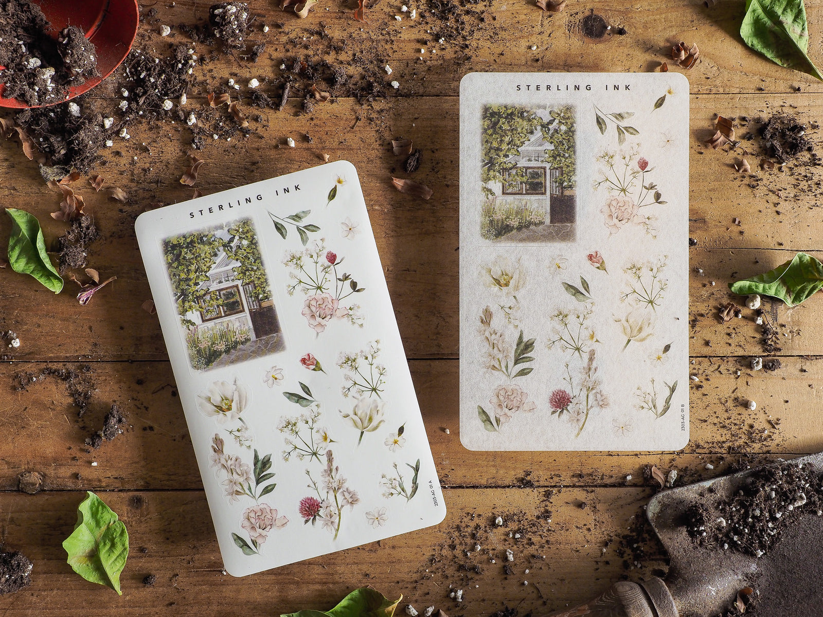 Botanical sticker sheets featuring delicate spring arrangements of soft pastel flowers, abundant greenery, and a charming house illustration.