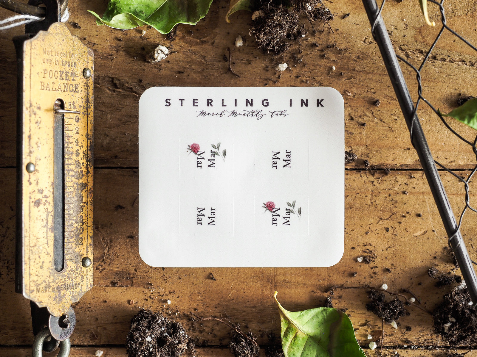 A set of neatly printed, white monthly planning tabs from Sterling Ink, displaying calendar abbreviations for planning and scheduling months like March and May.