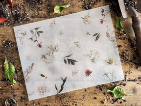 Delicate botanical vellum sheet featuring an ethereal pattern of muted dried flowers, delicate stems, and pressed leaves, suitable for journaling or crafting.
