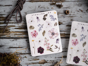 A delicate sticker sheet featuring watercolor botanical elements in muted pastels, displaying various blossoms and lush foliage.