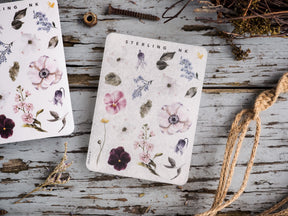 Watercolor sticker elements featuring a variety of botanical designs, including vibrant pink poppies, purple lavender, and delicate blue filler flowers.