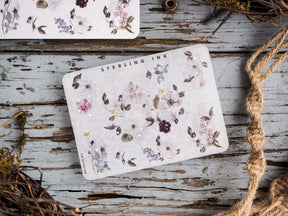 Delicate sticker sheet featuring watercolor floral clusters of purples and pinks, perfect for adding decorative touches to journals and planners.
