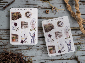 Botanical icon sticker sheets for April 2023, featuring pressed flowers, rustic potted plants, delicate frames, and decorative silver foil accents.