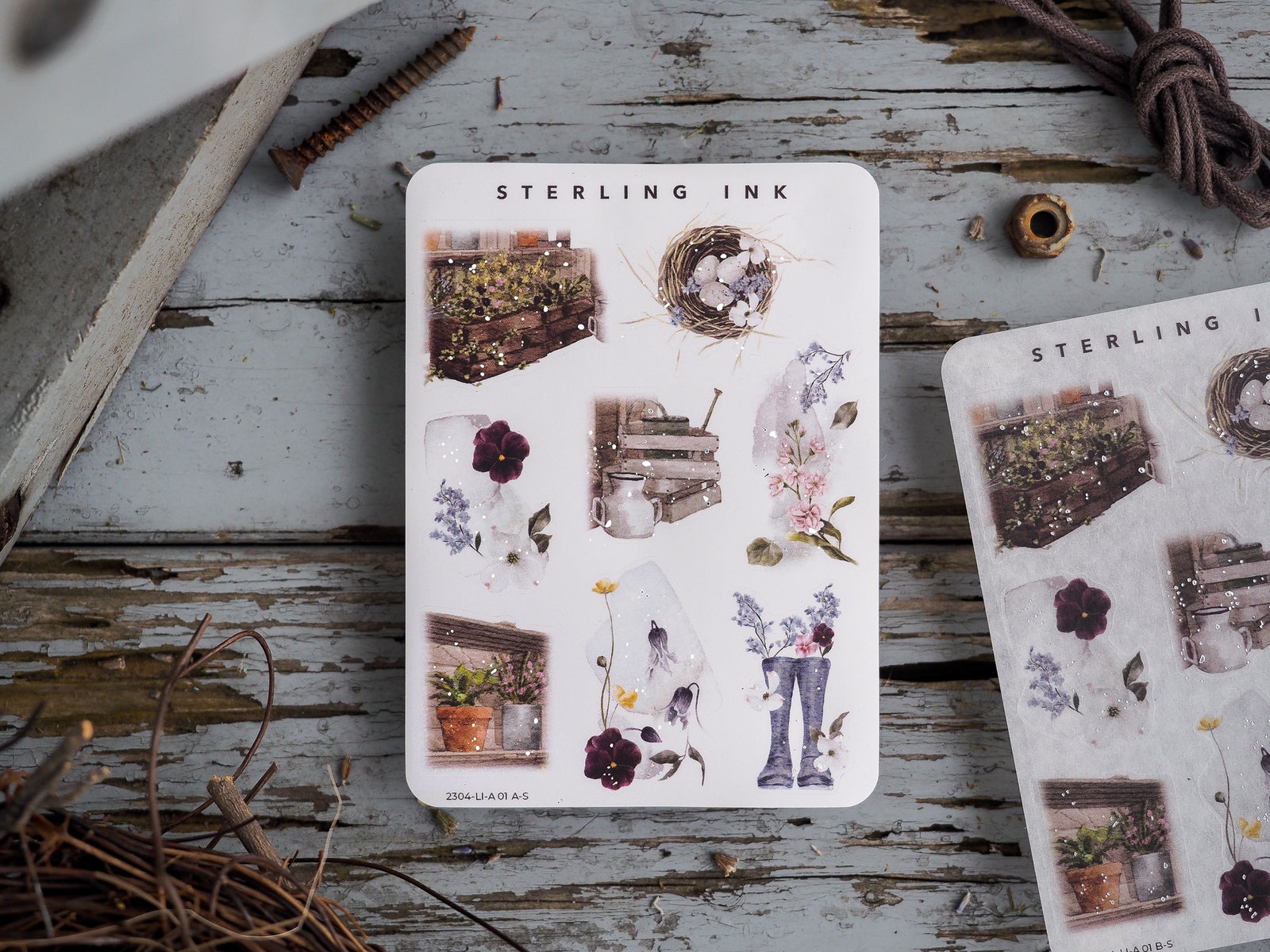 Sheet of detailed sticker illustrations featuring a spring garden theme, including potted plants, floral bouquets, and rustic nature elements in soft, muted tones.