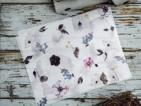Watercolor floral sheet featuring soft spring blossoms, deep purple flowers, and scattered blue foliage on a delicate white background.