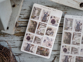 Sheet of detailed vintage scrapbook stickers featuring muted florals, antique architectural elements, and charming scenes of ornate furniture.
