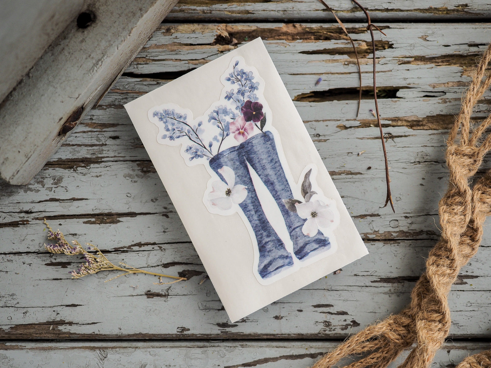 Watercolor-style die-cut sticker featuring a stylized letter I adorned with delicate blue, purple, and white spring florals, perfect for seasonal crafting.
