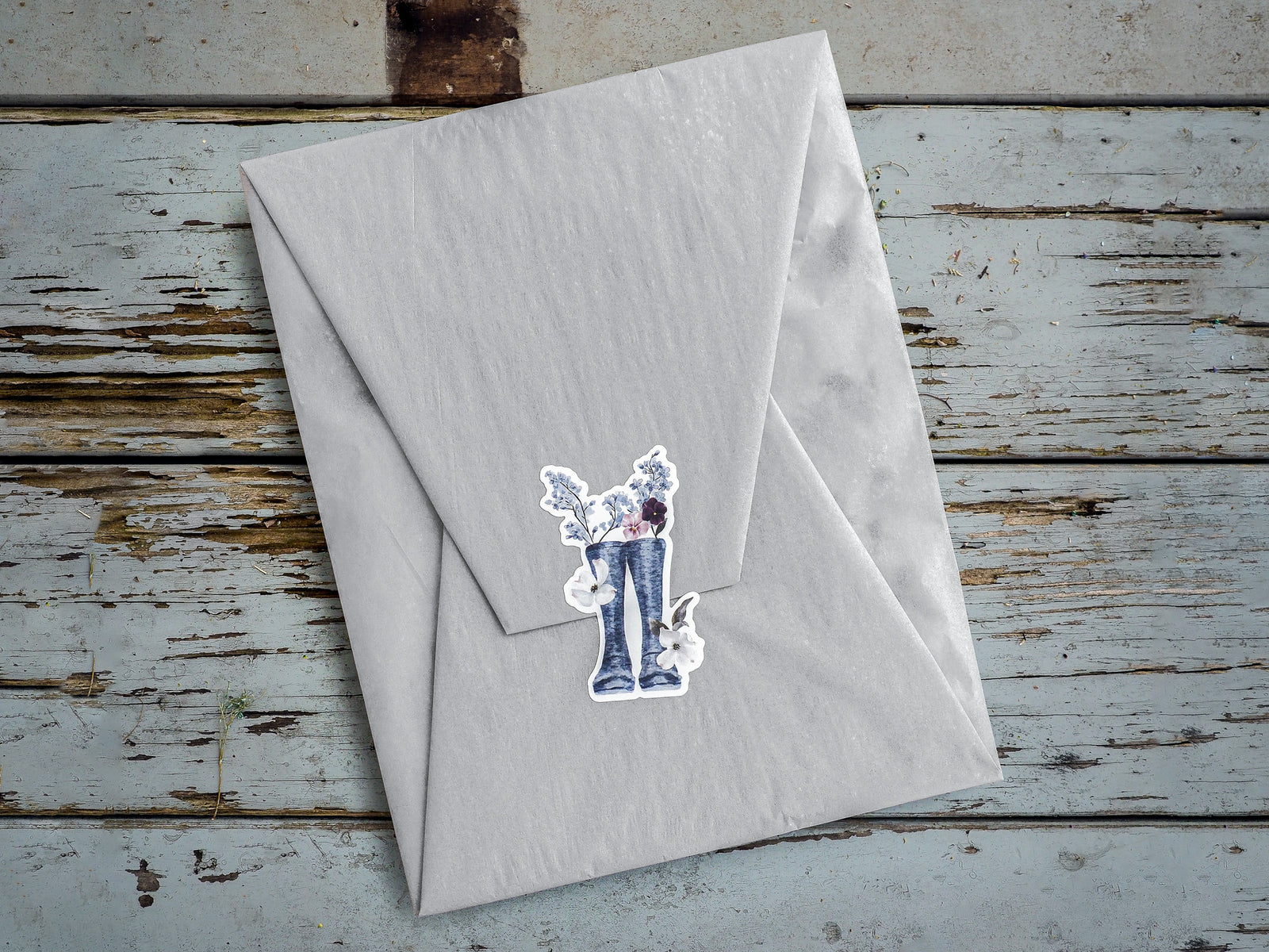 Die-cut vinyl stickers featuring blue denim jeans paired with delicate floral clusters and green foliage, evoking a sweet, spring garden theme.