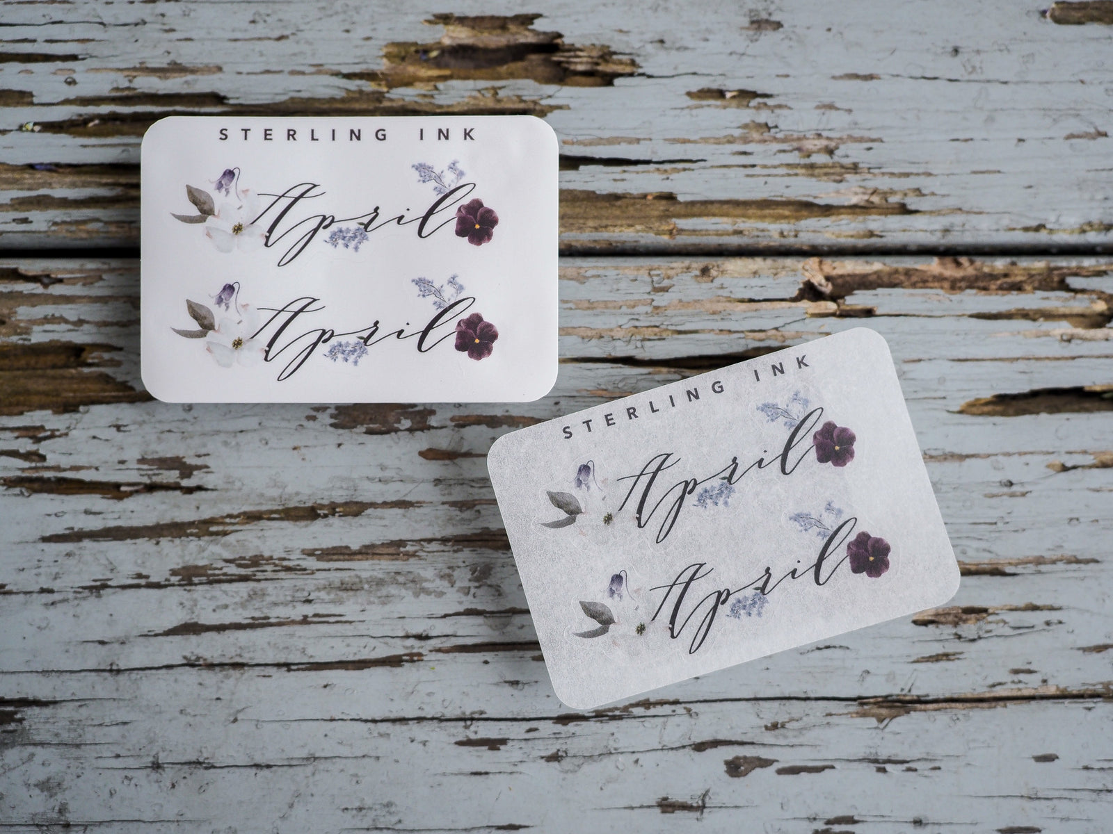 Decorative April month stickers featuring "STERLING INK" and delicate purple and cream floral watercolor accents for planners and journaling.