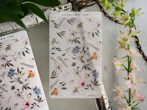 Watercolor botanical sticker strip adorned with soft pastel illustrations of mixed wildflowers, leaves, and greenery.