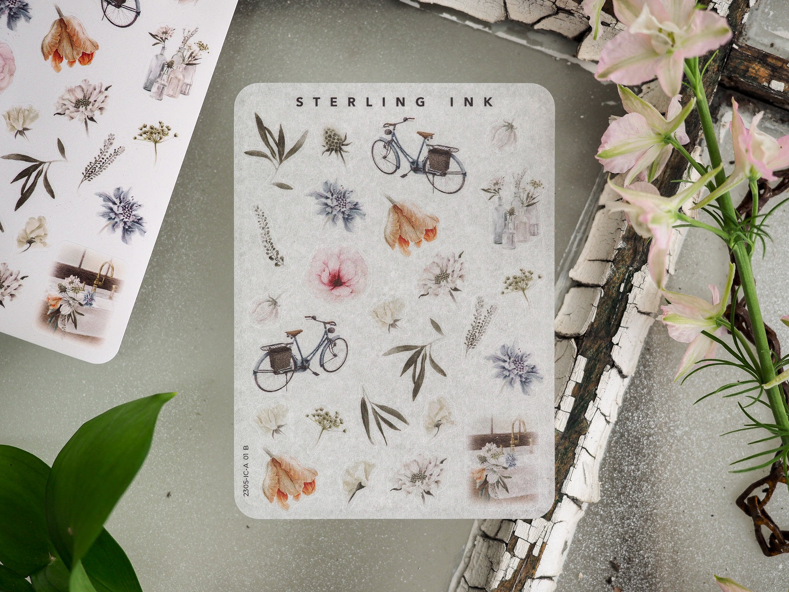 Charming sticker set featuring botanical and whimsical icons, including watercolor florals, leafy branches, small wildflowers, and vintage bicycles.
