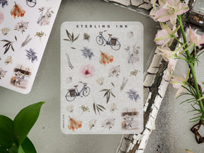 Charming sticker set featuring botanical and whimsical icons, including watercolor florals, leafy branches, small wildflowers, and vintage bicycles.