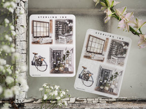Detailed sticker sheets featuring large, vintage architectural illustrations of cozy interiors, city windows, and charming urban scenes.