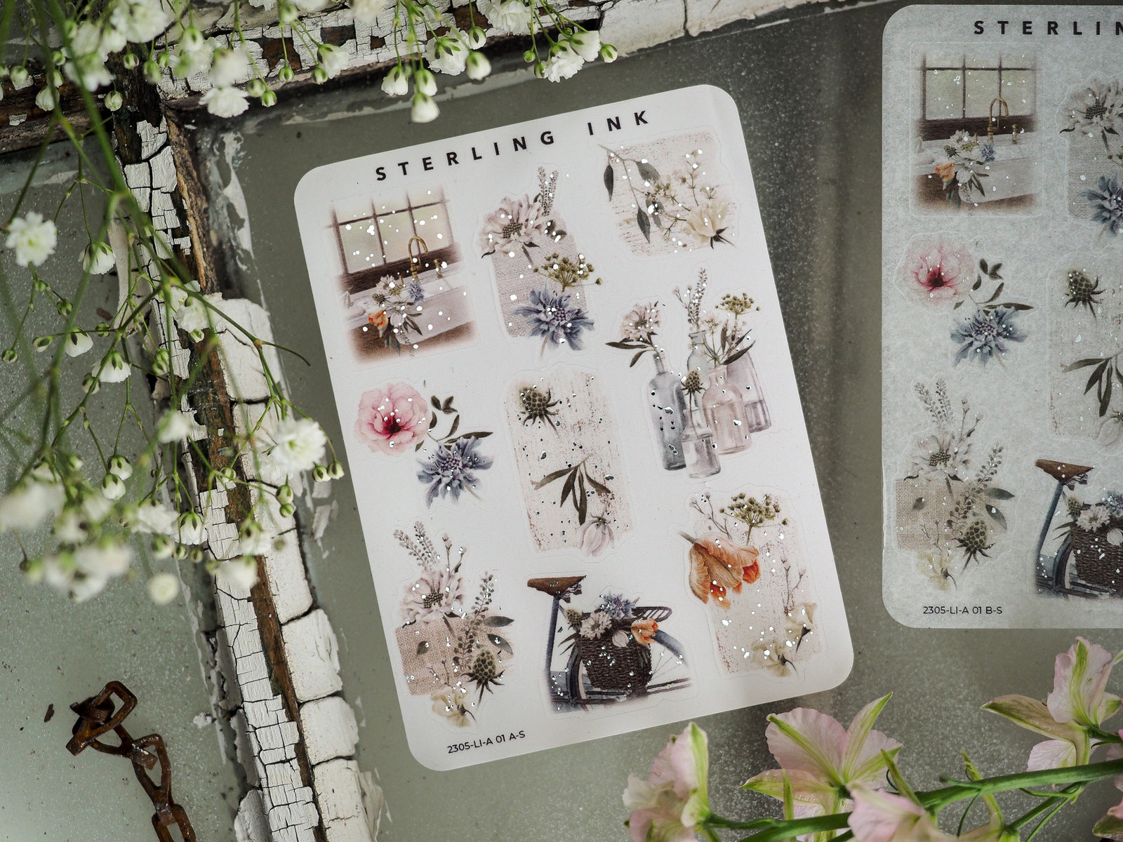 Sheet of large icon stickers featuring delicate silver foil accents, clusters of watercolor florals, and dried botanical elements for crafting.
