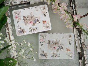Decorative sticker sheets featuring vintage botanical bouquets, soft pastel flowers in pink and blue, and shimmering silver foil accents for journaling.