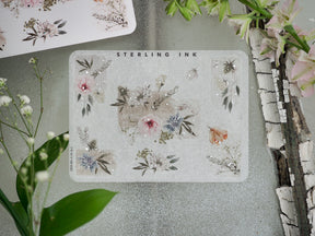 Delicate sticker set featuring soft pastel florals, botanical leaves, and accent elements highlighted with elegant silver foil for journaling.