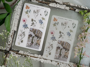 Botanical sticker sheets featuring delicate spring bouquets, peonies, and foliage surrounding an elegant, vintage illustration of a European cobblestone street.