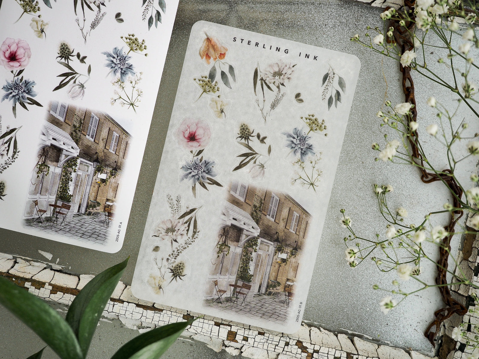 Decorative stickers combining delicate watercolor florals in pink and blue with an architectural scene of a charming, ivy-covered European street facade.