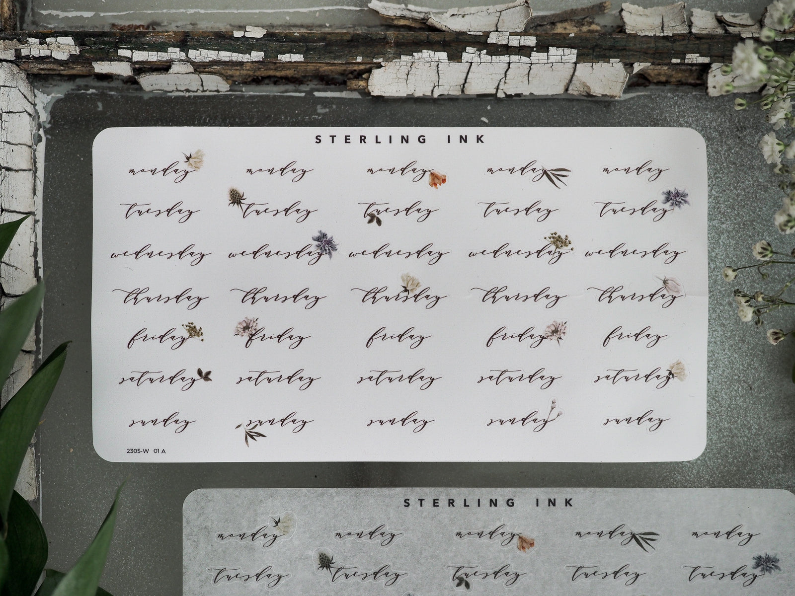 Calendar sticker set for May 2023 featuring days of the week and organized weekly labels, printed on cream paper with delicate black text and small floral accents.
