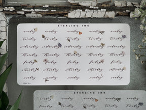 Calendar sticker set for May 2023 featuring days of the week and organized weekly labels, printed on cream paper with delicate black text and small floral accents.