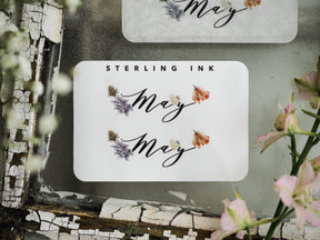 Elegant "May" sticker with decorative watercolor florals and graceful script, perfect for journaling and decorating monthly planners.