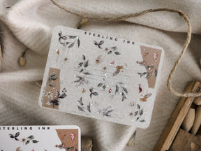 Botanical sticker sheet featuring muted dried leaves and corner designs accented with delicate silver foil for journaling and scrapbooking.