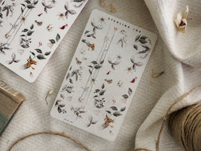 Muted botanical washi sticker sheet featuring clustered arrangements of dried leaves, tiny berries, and delicate seasonal autumn flora perfect for journaling.