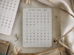 White planner sticker grid for December 2022, featuring numbered circles under the 'Sterling Ink' logo for easy date planning and journaling.