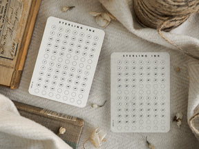 Coordinating white date stickers featuring clean black circular grids, perfect for planning, journaling, and organizing monthly schedules.