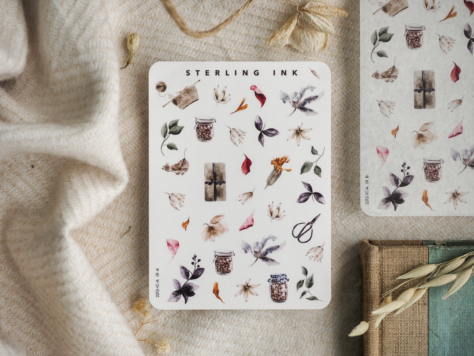 Detailed sticker sheet showcasing muted, seasonal botanical elements, including dried leaves, flower clusters, miniature apothecary jars, and rustic natural icons.