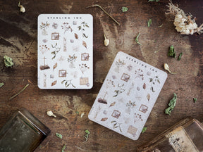 Miniature sticker set featuring delicate, hand-drawn botanical icons, including leaves, flowers, and rustic framed elements printed on clean white paper.