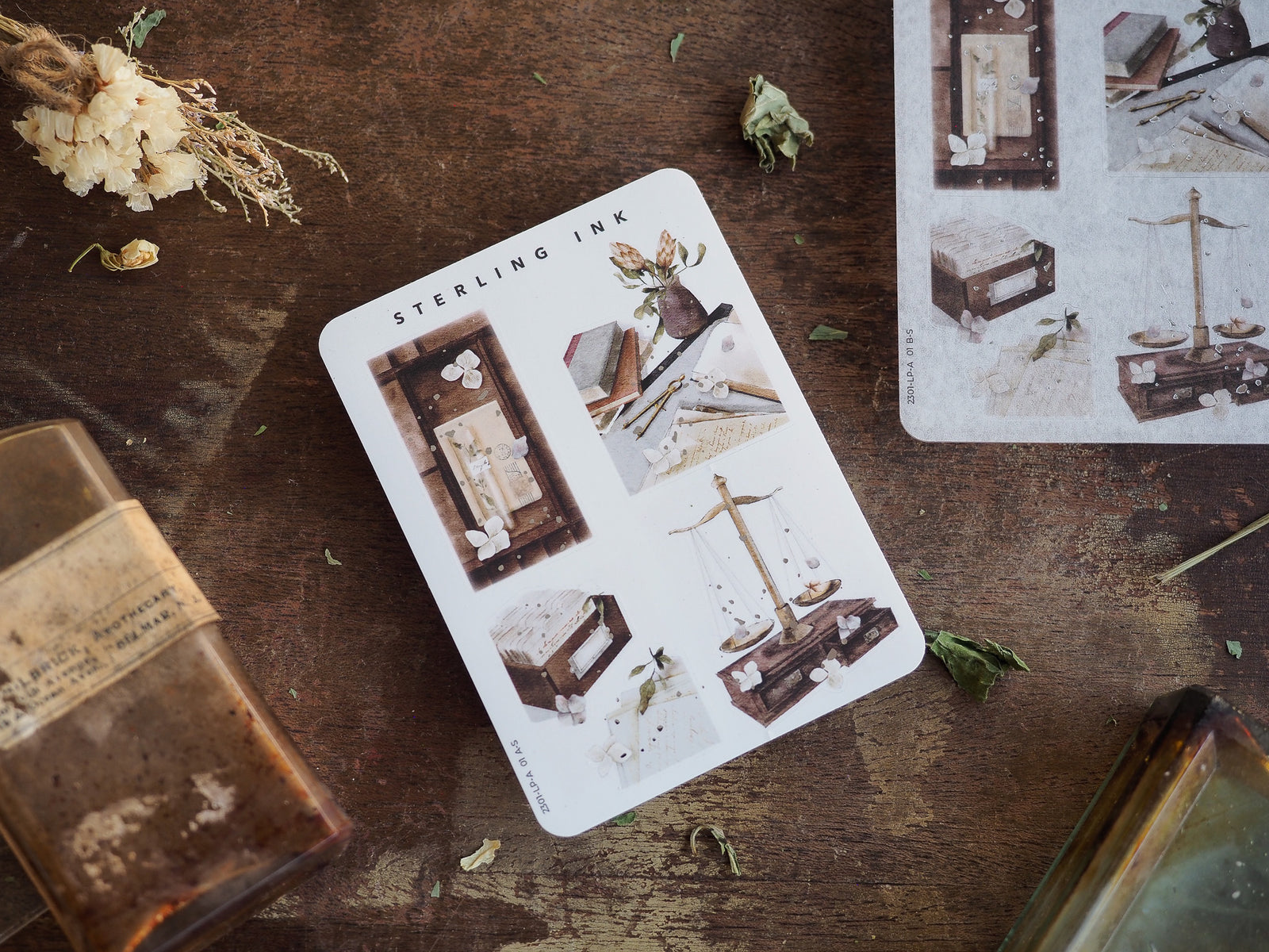 Vintage sepia illustration stickers featuring elegant designs of stacked books, ornate picture frames, and a detailed model sailing ship.