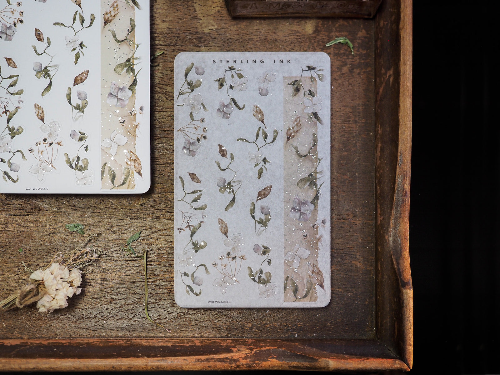 Elegant washi strips featuring a soft, botanical pattern of muted pressed flowers, delicate leaves, and dried foliage perfect for journaling.