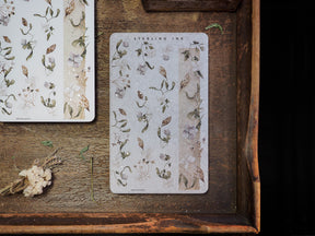 Elegant washi strips featuring a soft, botanical pattern of muted pressed flowers, delicate leaves, and dried foliage perfect for journaling.