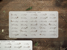 Rustic off-white sticker sheets designed for planning, displaying weekly days like Monday through Sunday in an elegant, vintage script perfect for journaling and calendars.