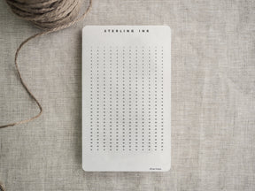 White, structured tracker strip featuring a clean, numbered grid layout for planning and daily scheduling, designed for compatibility with common planners.