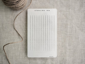 White planner tracker strips featuring "Sterling Ink" branding and organized grids perfect for customizable vertical and horizontal goal or habit tracking.