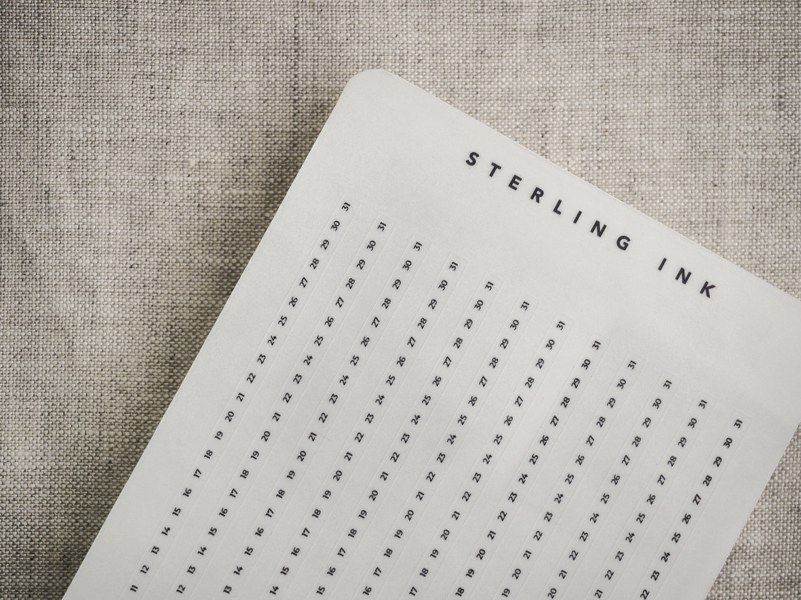Off-white tracker strips featuring a clean, numbered grid layout designed for common planners, allowing users to track dates vertically and horizontally.