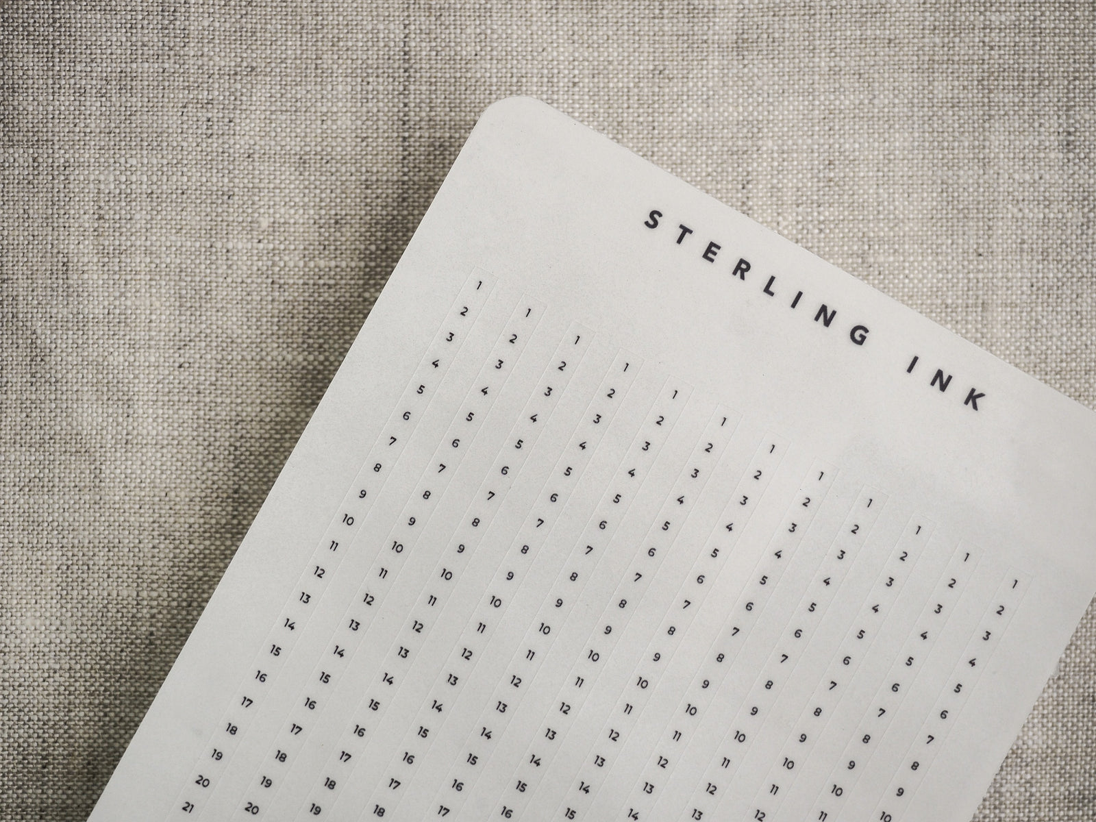 Structured white grid strips for planning and tracking, featuring a numbered format and a decorative "STERLING INK" title compatible with various planners.