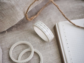 White washi tape featuring a printed hourly schedule of black numbers 1 through 12, designed for organizing planners and grid notebooks.